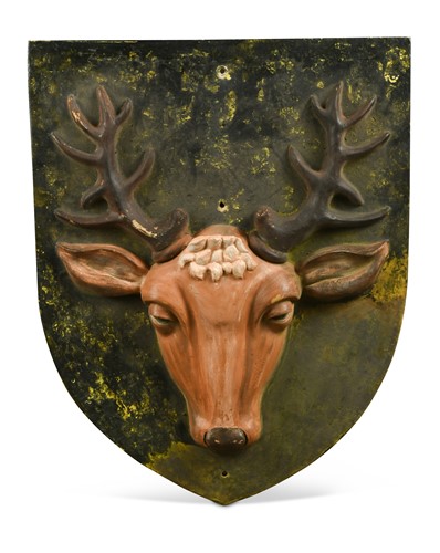 Lot 794 - A painted terracotta shield-shaped wall mount