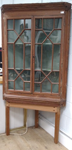 Lot 354 - An early 19th century pine corner cupboard on...