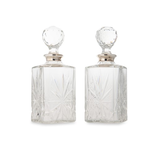 Lot 436 - A pair of Elizabeth II cut glass spirit decanters with silver collars, mark of Asprey