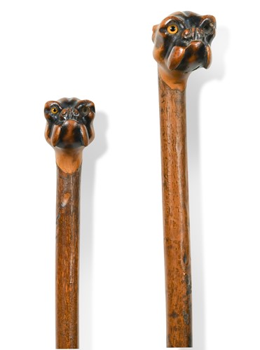 Lot 742 - A near pair of carved walking canes, late 19th or early 20th century