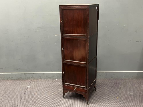 Lot 395 - A tall mahogany three door cabinet with single...