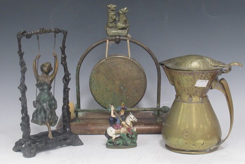 Lot 23 - A reproduction bronze female figure on a swing...