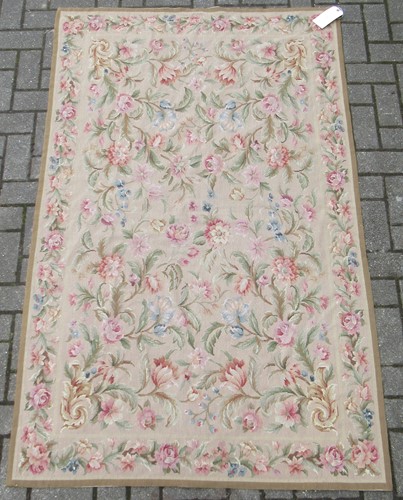 Lot 492 - An English needlepoint floor covering with...