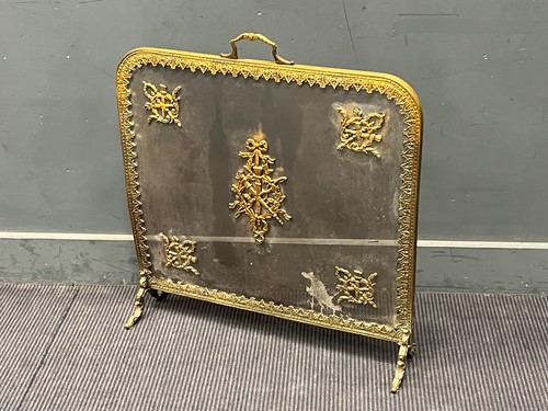 Lot 374 - An early 20th century gilt metal fire guard...