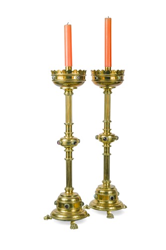 Lot 73 - A pair of Victorian Reformed Gothic brass and 'amethyst' mounted candlesticks