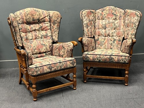 Lot 473 - A pair of Ercol stained elm wing back...