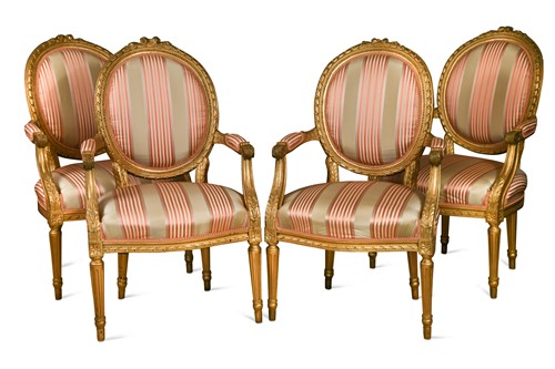 Lot 306 - A set of four carved and giltwood salon armchairs in the Louis XVI style, 19th century