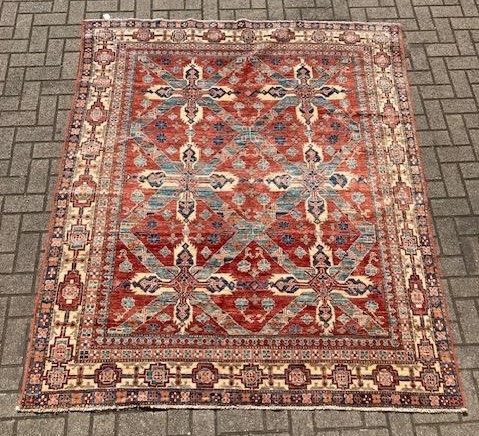 Lot 497 - A red ground with blue geometric pattern wool...
