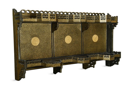 Lot 216 - A papier-mâché gilt and black-painted hanging wall shelf, late 19th century