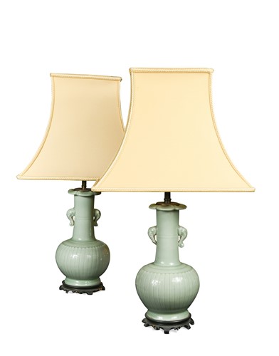 Lot 227 - A pair of green celadon vase lamps on carved wood bases, 20th century