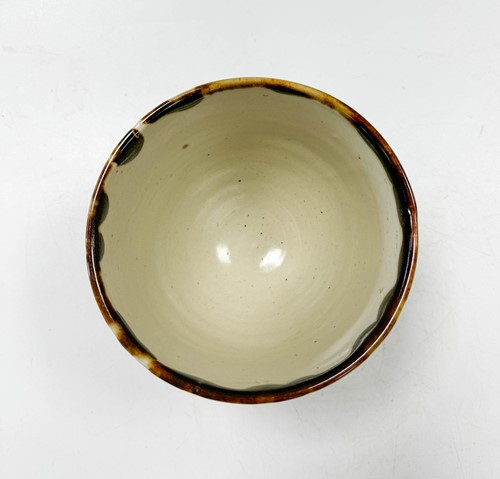 Lot 55 - Bernard Leach (1887-1979), a St. Ives cut-sided bowl, circa 1960