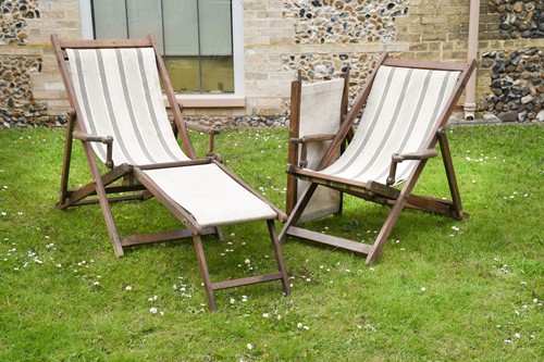 Lot 824 - A pair of good Edwardian teak-framed deck chairs with detachable foot rests