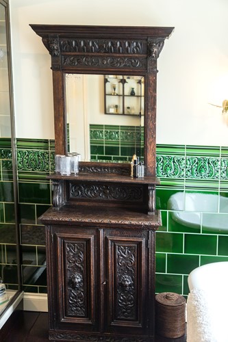 Lot 582 - A narrow Victorian carved oak mirror backed cabinet
