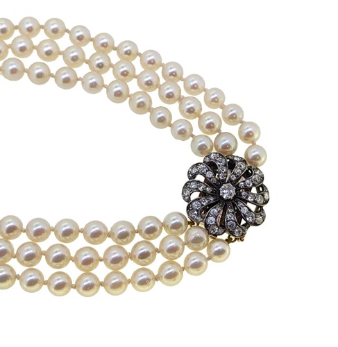 Lot 25 - A three row cultured pearl necklace with a diamond set clasp