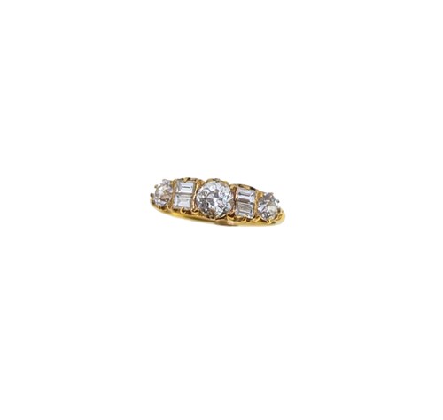 Lot 63 - A carved half hoop style diamond ring