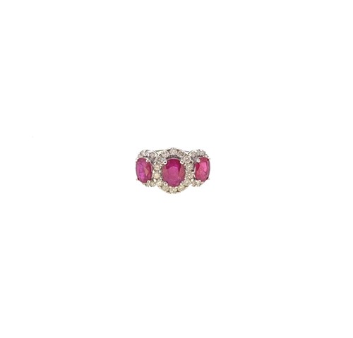 Lot 91 - A 9ct gold glass filled ruby and diamond cluster ring