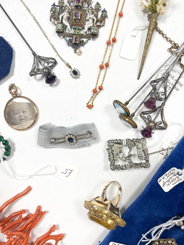 Lot 316 - A collection of hat pins together with a stone...