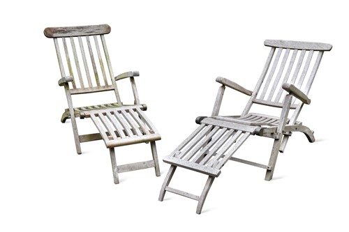 Lot 826 - A near pair of greyed-teak folding steamer chairs