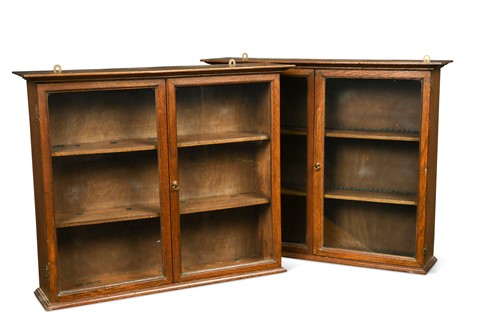 Lot 694 - A pair of Edwardian wall-mounted oak collectors cabinets