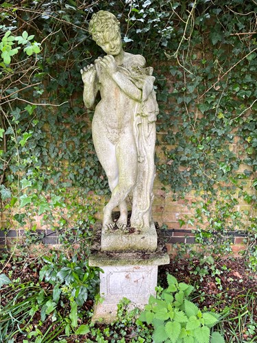 Lot 830 - A reconstituted stone figure of a young pipe player after the Antique, late 20th century