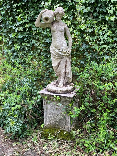 Lot 820 - A female water carrier garden statue after the Antique