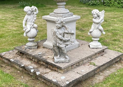 Lot 420 - A group of four composition putto garden statues, 20th century