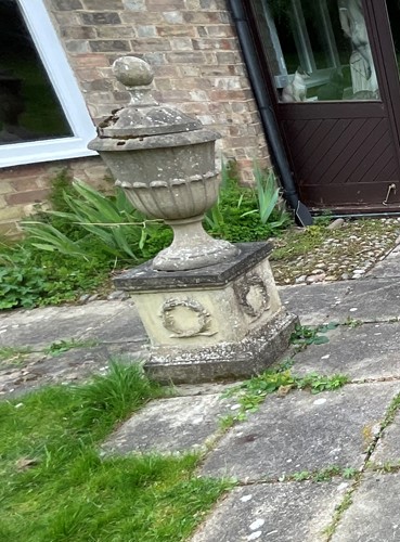 Lot 842 - A pair of reconstituted stone lidded urns, 20th century