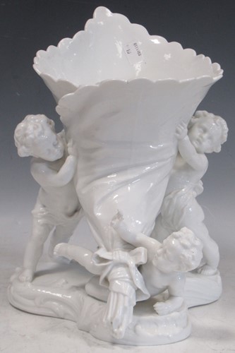 Lot 146 - A Continental white glazed vase supported by...