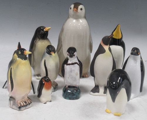 Lot 112 - Ceramic collection of amusing penguins in...