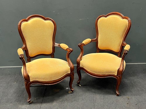 Lot 547 - A pair of French walnut salon armchairs, or...