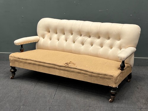 Lot 613 - A late Victorian ebonised button back sofa,...