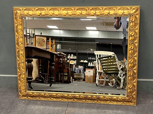 Lot 616 - A modern gilt rectangular wall mirror, the...