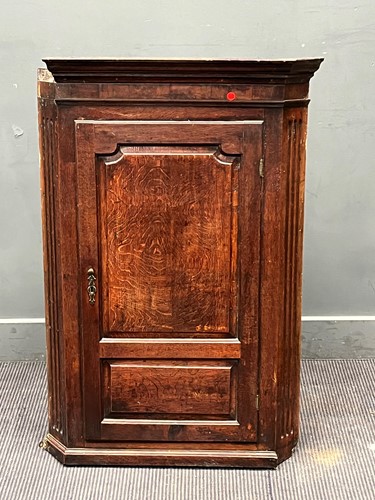 Lot 458 - An 18th century oak corner cupboard, the...