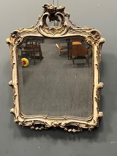 Lot 612 - A white painted and parcel gilt wall mirror in...