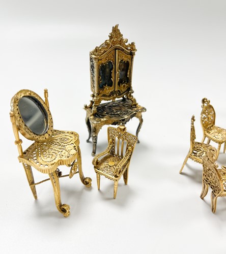 Lot 183 - A collection of gilt metal dolls' house furniture