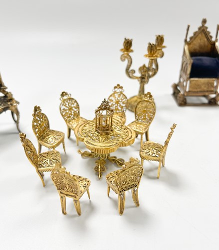 Lot 183 - A collection of gilt metal dolls' house furniture