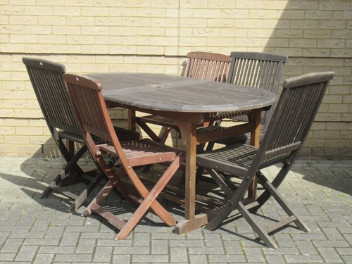 Lot 685 - A teak garden dining table 75 x 171 x 100cm...
