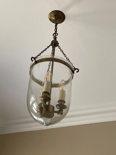 Lot 673 - A three lamp brass ceiling light with clear...