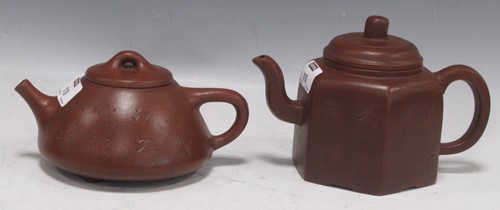 Lot 21 - Two Chinese Yixing tea pots, each with...