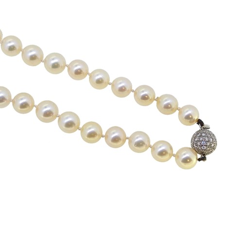 Lot 26 - An opera length cultured pearl necklace with a diamond clasp