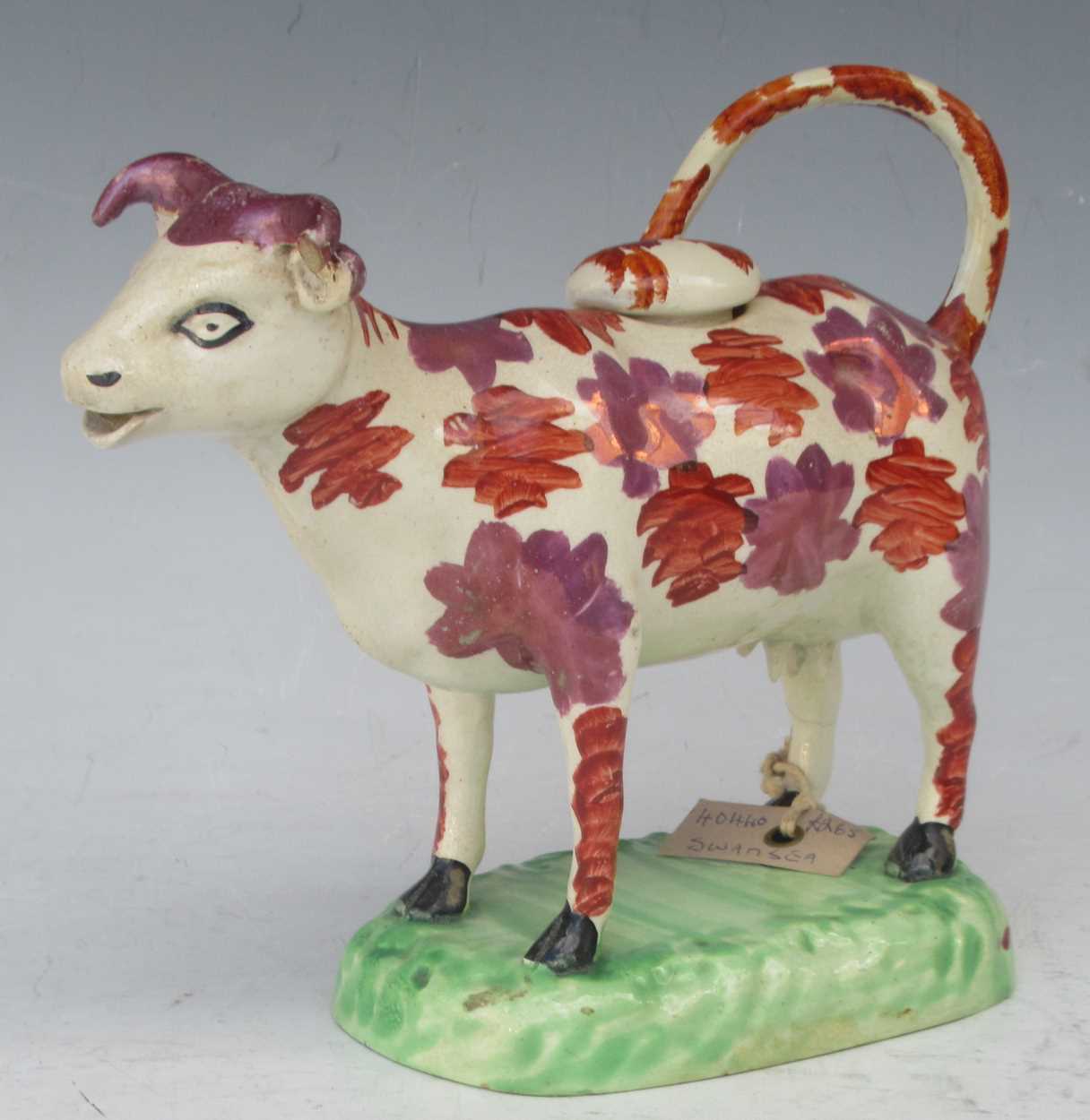 Lot 12 - An early 19th century Swansea cow creamer with...