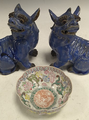 Lot 81 - A pair of Chinese blue glazed dogs of Fo,...