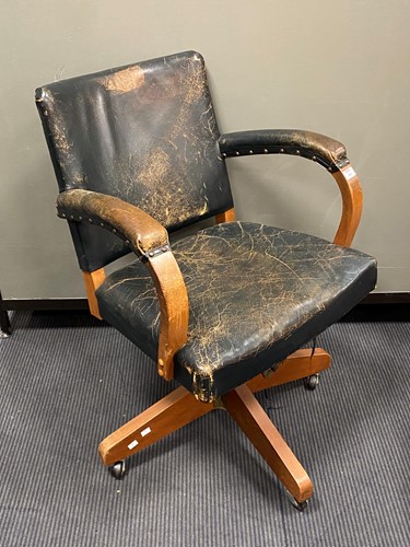 Lot 593 - An office swivel chair, with downswept arms...