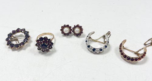 Lot 169 - A sapphire and diamond cresecnt brooch, tested...