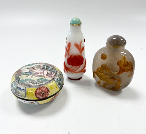Lot 30 - A Chinese Canton enamel small boy and dog box and cover, Qing Dynasty 18/19th century