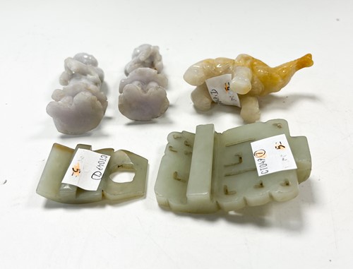 Lot 29 - A Chinese light green jade archaic style belt buckle, Qing Dynasty, 19th century