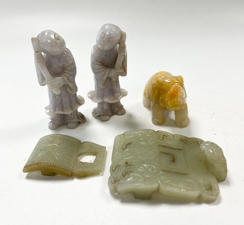 Lot 29 - A Chinese light green jade archaic style belt buckle, Qing Dynasty, 19th century