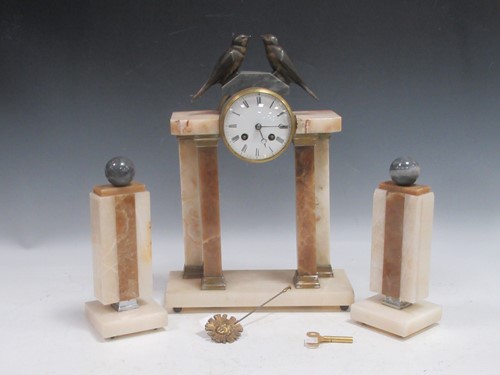 Lot 139 - A French Art Deco polished stone clock...