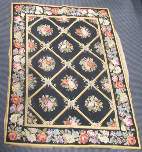 Lot 492 - An English needlepoint tapestry floor covering,...