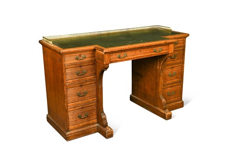 Lot 220 - An Aesthetic period oak pedestal desk by Gillow & Co.